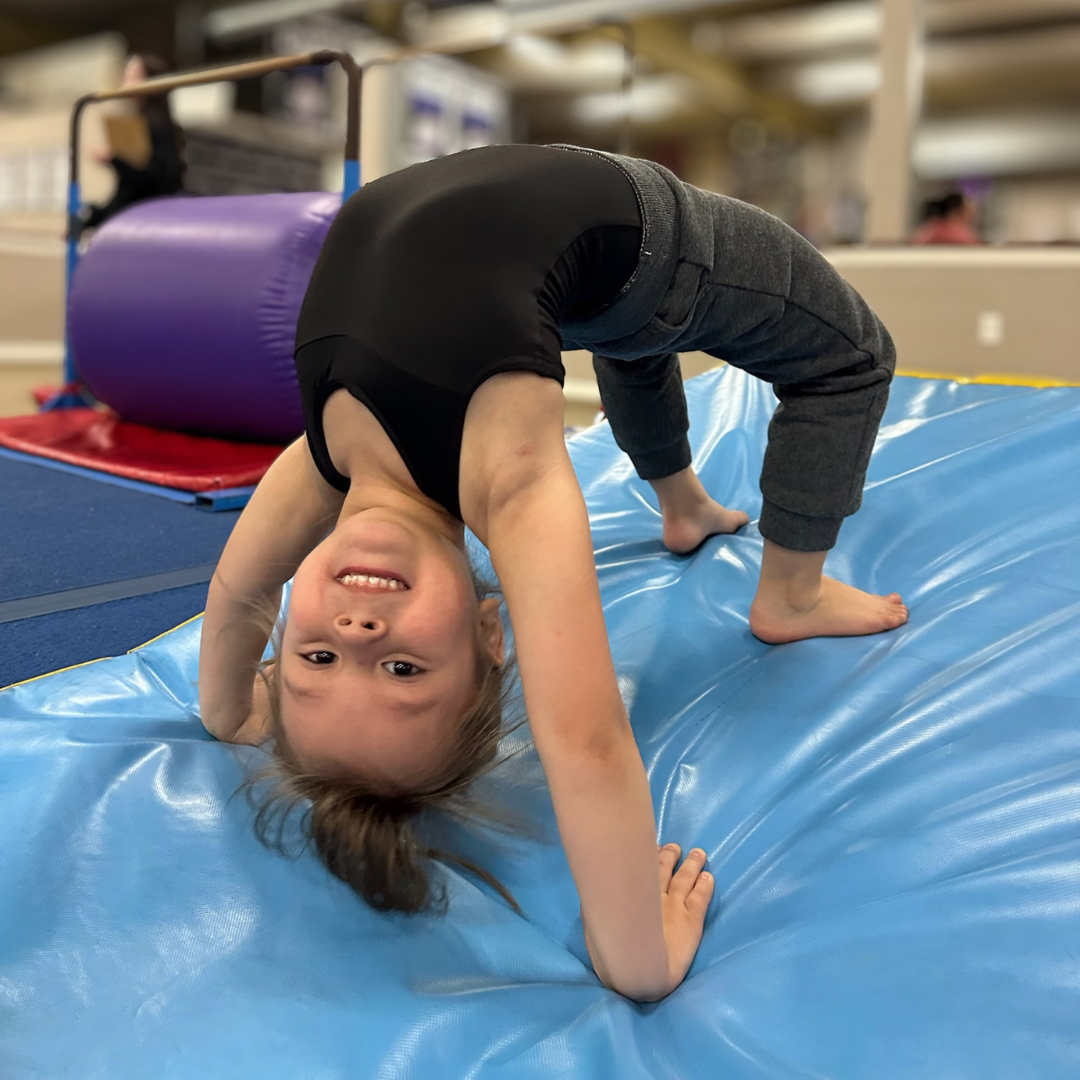 Preschool gymnast practicing a bridge